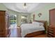 Tranquil main bedroom with lanai access and hardwood floors at 14404 18Th E Pl, Bradenton, FL 34212