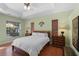 The main bedroom features a tray ceiling and serene decor at 14404 18Th E Pl, Bradenton, FL 34212