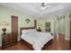 Bright main bedroom with hardwood floors, tray ceiling, and palm tree decor at 14404 18Th E Pl, Bradenton, FL 34212