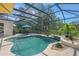 Screened-in pool featuring lush landscaping and outdoor cooking space, creating a relaxing outdoor oasis at 14404 18Th E Pl, Bradenton, FL 34212