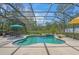 Inviting screened-in pool area with lush landscaping and a peaceful view of the surrounding greenery at 14404 18Th E Pl, Bradenton, FL 34212