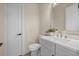 Elegant half bathroom featuring modern fixtures, a framed mirror, and a single sink vanity at 193 Rotonda N Blvd, Rotonda West, FL 33947