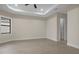 Spacious bedroom with tray ceiling, recessed lights and neutral colors at 193 Rotonda N Blvd, Rotonda West, FL 33947
