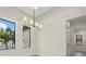 Bright dining room featuring modern light fixture, neutral paint, and large windows at 193 Rotonda N Blvd, Rotonda West, FL 33947