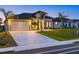 Striking one-story house with lush lawn, a two-car garage, and an interlocking brick driveway at 193 Rotonda N Blvd, Rotonda West, FL 33947