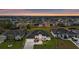 Aerial view of a modern home in a residential neighborhood at sunset; meticulously landscaped with a paved driveway at 193 Rotonda N Blvd, Rotonda West, FL 33947