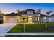 Beautiful single-story home showcasing a landscaped front yard and a two-car garage, enhancing curb appeal at 193 Rotonda N Blvd, Rotonda West, FL 33947