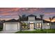 Inviting single-story home with manicured lawn, striking modern architectural details, and a two-car garage at 193 Rotonda N Blvd, Rotonda West, FL 33947