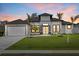 Charming home with a manicured lawn, double door entry, and ample garage space, set against a colorful sky at 193 Rotonda N Blvd, Rotonda West, FL 33947