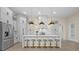Modern kitchen with a quartz countertop island, stainless steel appliances, and sleek pendant lighting at 193 Rotonda N Blvd, Rotonda West, FL 33947
