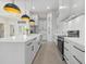 Well-equipped kitchen with white cabinets, stainless steel appliances, and an island with a sink at 193 Rotonda N Blvd, Rotonda West, FL 33947