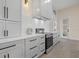 Modern kitchen featuring white cabinets, stainless steel appliances, and stylish countertops at 193 Rotonda N Blvd, Rotonda West, FL 33947