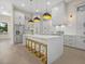 Spacious kitchen with white cabinetry, a large center island with seating, and stainless steel appliances at 193 Rotonda N Blvd, Rotonda West, FL 33947