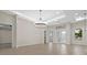 Spacious living area with tile floors, high ceilings, and a stunning decorative lighting fixture at 193 Rotonda N Blvd, Rotonda West, FL 33947