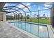 Screened in pool overlooking expansive backyard and beautiful blue sky at 193 Rotonda N Blvd, Rotonda West, FL 33947