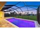 A backyard swimming pool has purple lights and a full screened enclosure at 193 Rotonda N Blvd, Rotonda West, FL 33947