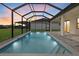 A screened-in pool features cool blue water and stylish tile with easy access to the home at 193 Rotonda N Blvd, Rotonda West, FL 33947