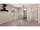 A bedroom features a window AC unit, shelf, and tile flooring leading to an open bathroom at 203 Peacock Ln # B, Holmes Beach, FL 34217