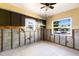 View of kitchen with dark wooden cabinets, tile floors and a window with natural light at 203 Peacock Ln # B, Holmes Beach, FL 34217