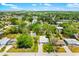Sprawling aerial view showcases the property with mature trees and beautiful landscaping under a bright, sunny sky at 2225 Alice Rd, Sarasota, FL 34231