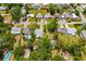 Wide aerial view of neighborhood with mature trees, showcasing location and nearby amenities under a bright, sunny sky at 2225 Alice Rd, Sarasota, FL 34231