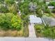 Aerial view of the property showcasing the home, expansive yard, mature trees, and proximity to neighborhood amenities at 2225 Alice Rd, Sarasota, FL 34231