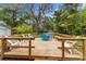 Outdoor entertaining space with a wooden deck and charming backyard setting at 2225 Alice Rd, Sarasota, FL 34231