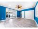 Bedroom features bright blue accent wall and sliding door to the outside at 2225 Alice Rd, Sarasota, FL 34231
