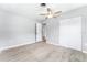 Bright bedroom featuring wood-look floors, a ceiling fan and a closet at 2225 Alice Rd, Sarasota, FL 34231