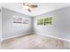 Well-lit bedroom features sleek wood-look flooring and bright windows at 2225 Alice Rd, Sarasota, FL 34231