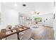 Open-concept dining room connected to living room with hardwood floors and stylish decor at 2225 Alice Rd, Sarasota, FL 34231
