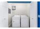 Laundry room with a washer and dryer and an on-demand hot water heater at 2225 Alice Rd, Sarasota, FL 34231
