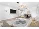 Comfortable living room with neutral tones, a wall-mounted TV, and access to dining at 2225 Alice Rd, Sarasota, FL 34231