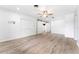 Spacious living room with modern flooring, barn doors, and ample natural light at 2225 Alice Rd, Sarasota, FL 34231