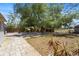 Spacious backyard features a large tree, privacy fence and a paved patio area at 2303 Stratford Dr, Sarasota, FL 34232