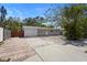 Charming single-story home with a brick driveway and lush trees adding curb appeal at 2303 Stratford Dr, Sarasota, FL 34232