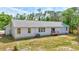 Backyard featuring a white home with a small deck and large yard with mature trees at 2425 21St St # B, Sarasota, FL 34234