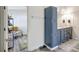 Bathroom with blue vanity and double sinks, next to a living area at 2425 21St St # B, Sarasota, FL 34234
