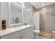 Well lit bathroom featuring a shower with decorative tile and a neutral color palette at 2425 21St St # B, Sarasota, FL 34234