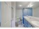 Bright bathroom featuring a soaking tub and blue vanity with double sinks at 2425 21St St # B, Sarasota, FL 34234