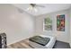 Spare bedroom has a large window with blinds, ceiling fan and minimal decor at 2425 21St St # B, Sarasota, FL 34234