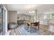 Inviting dining area with a rustic table, modern chandelier, and seamless access to the kitchen at 2425 21St St # B, Sarasota, FL 34234