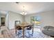 Inviting dining area with a rustic table, modern chandelier, and seamless access to the kitchen at 2425 21St St # B, Sarasota, FL 34234