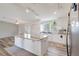 Bright kitchen with stainless steel appliances, a large island, and modern white cabinets at 2425 21St St # B, Sarasota, FL 34234