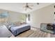 Bright main bedroom with ceiling fan, windows with blinds, and dog crate at 2425 21St St # B, Sarasota, FL 34234