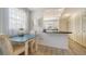 Bright kitchen with white cabinets, an open layout, and an adjacent dining area at 2634 Golf Course Dr # 316, Sarasota, FL 34234