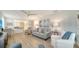 Inviting living area with wood-look floors, comfortable seating, and bright natural light throughout at 2634 Golf Course Dr # 316, Sarasota, FL 34234
