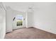 Bright, carpeted bedroom with a ceiling fan, window and closet, offering a simple retreat at 2665 Chipley Ave, North Port, FL 34286