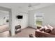 Bedroom with mounted TV, chair, ceiling fan, carpet, and closet offering a relaxing area at 2665 Chipley Ave, North Port, FL 34286
