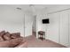 Bedroom with mounted TV, chair, ceiling fan, carpet, and closet offering a relaxing area at 2665 Chipley Ave, North Port, FL 34286